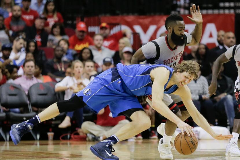 Dallas Mavericks forward Dirk Nowitzki (41) dives for a loose ball in front of Houston...