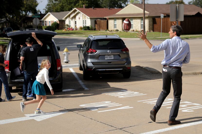U.S. Senate Democratic hopeful Beto O'Rourke throws the football with his daughter Molly,...