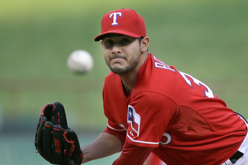 Texas Rangers starting pitcher Martin Perez throws during a baseball game against the...