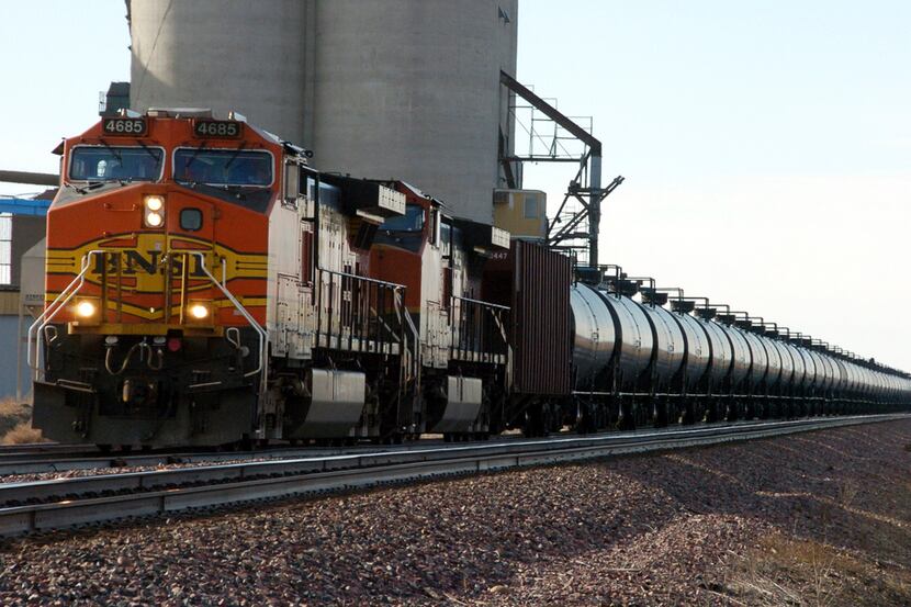 In this Nov. 6, 2013, file photo, a BNSF Railway train hauls crude oil near Wolf Point, Mont.