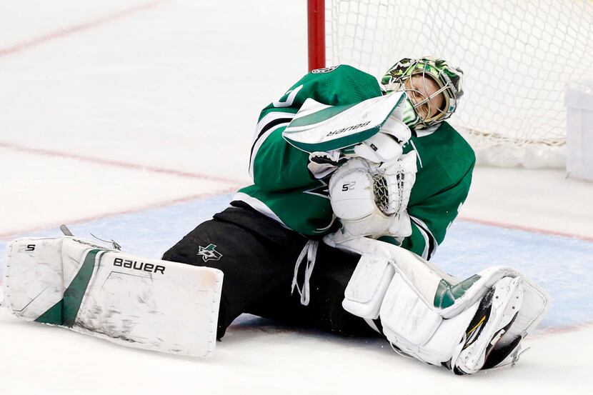 Dallas Stars goaltender Ben Bishop (30) goes to the ice after being hit by a slapshot by St....