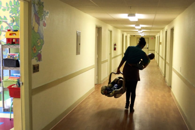 Jasmine Clark carried her twins to her room at the Samaritan Inn homeless shelter in...