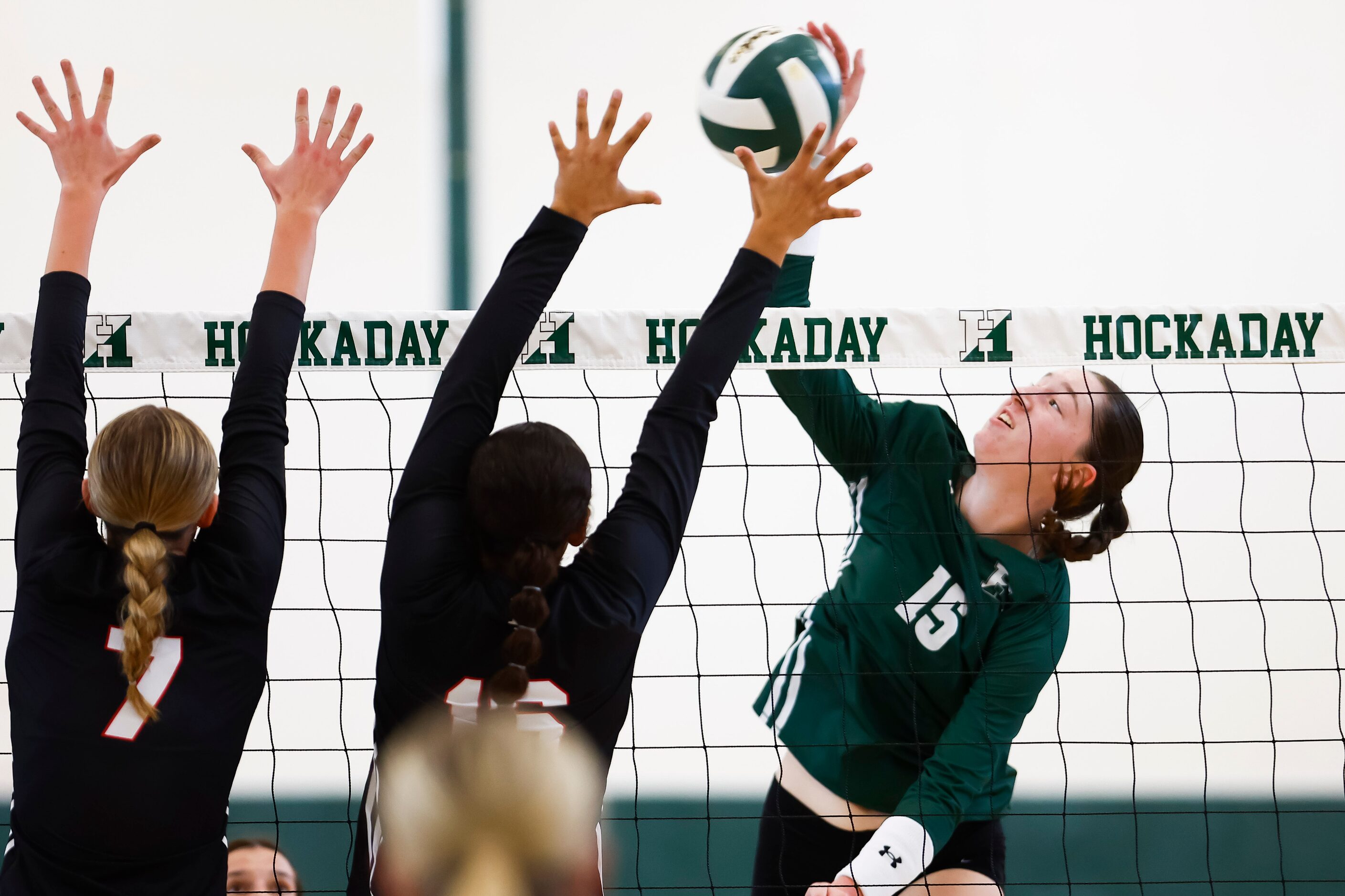 Hockaday junior middle blocker Olivia Wayne (15) hits the ball over the net as Love Joy...