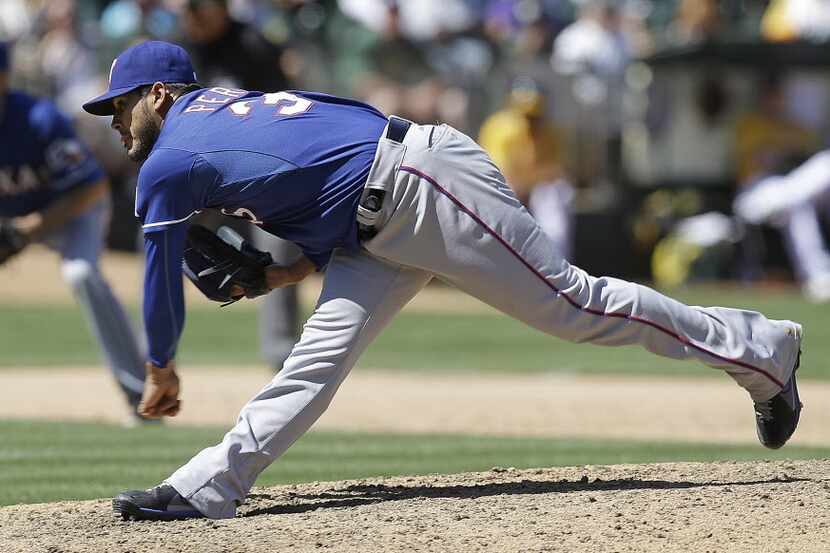 Texas Rangers' Martin Perez follows through on a pitch to the Oakland Athletics in the ninth...