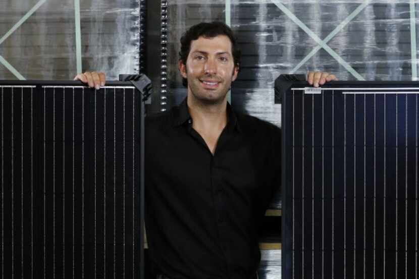 Abe Issa, CEO of Global Efficient Energy, with solar panels in the company's warehouse in...