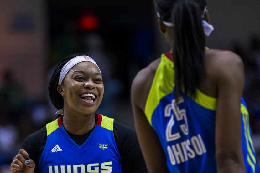 Dallas Wings guard Odyssey Sims (0) and forward Glory Johnson (25) share a laugh during the...