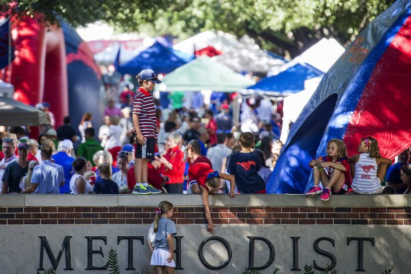 Fans tailgate on The Boulevard before an NCAA football game between North Texas and SMU at...