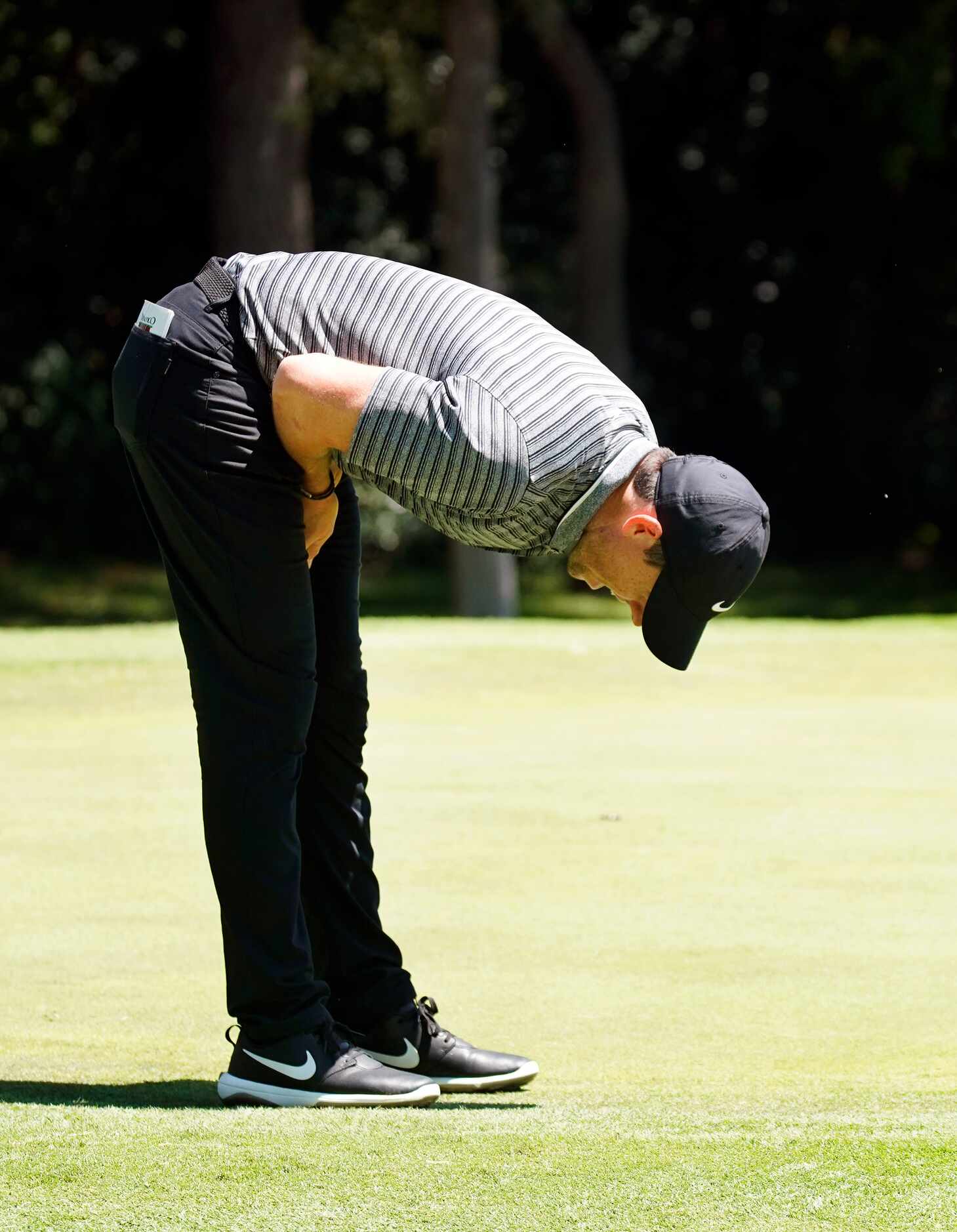 PGA Tour golfer Rory McIlroy reacts after missing a birdie putt on No. 8 during the second...