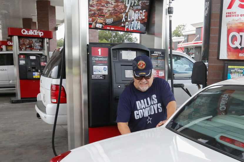 Rudy Garcia Sr. fills up his car at the QuikTrip on Zang Boulevard in Dallas on Aug. 30,...