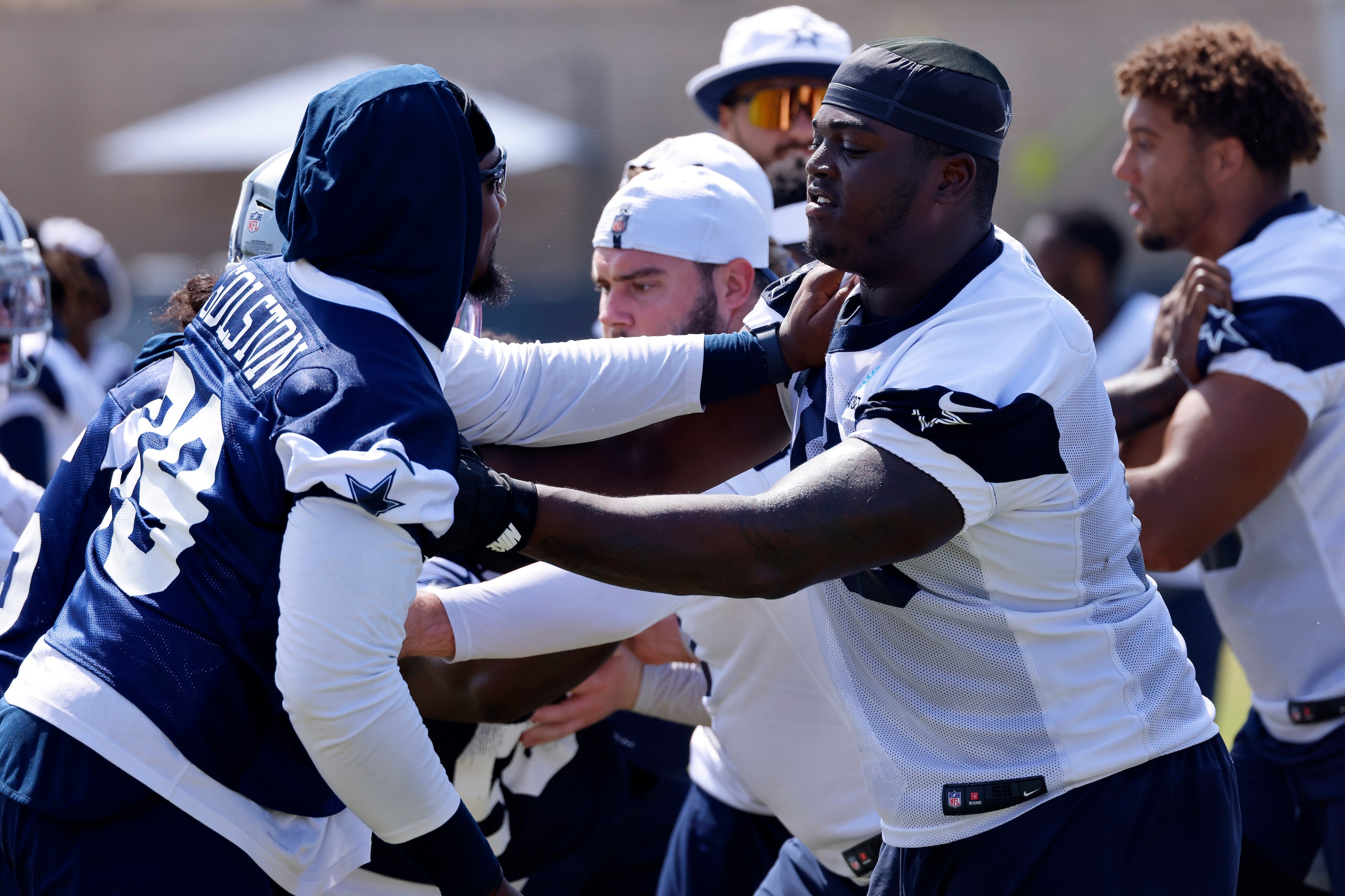 Dallas Cowboys offensive tackle Tyler Smith (right) and defensive end Chauncey Golston (99)...