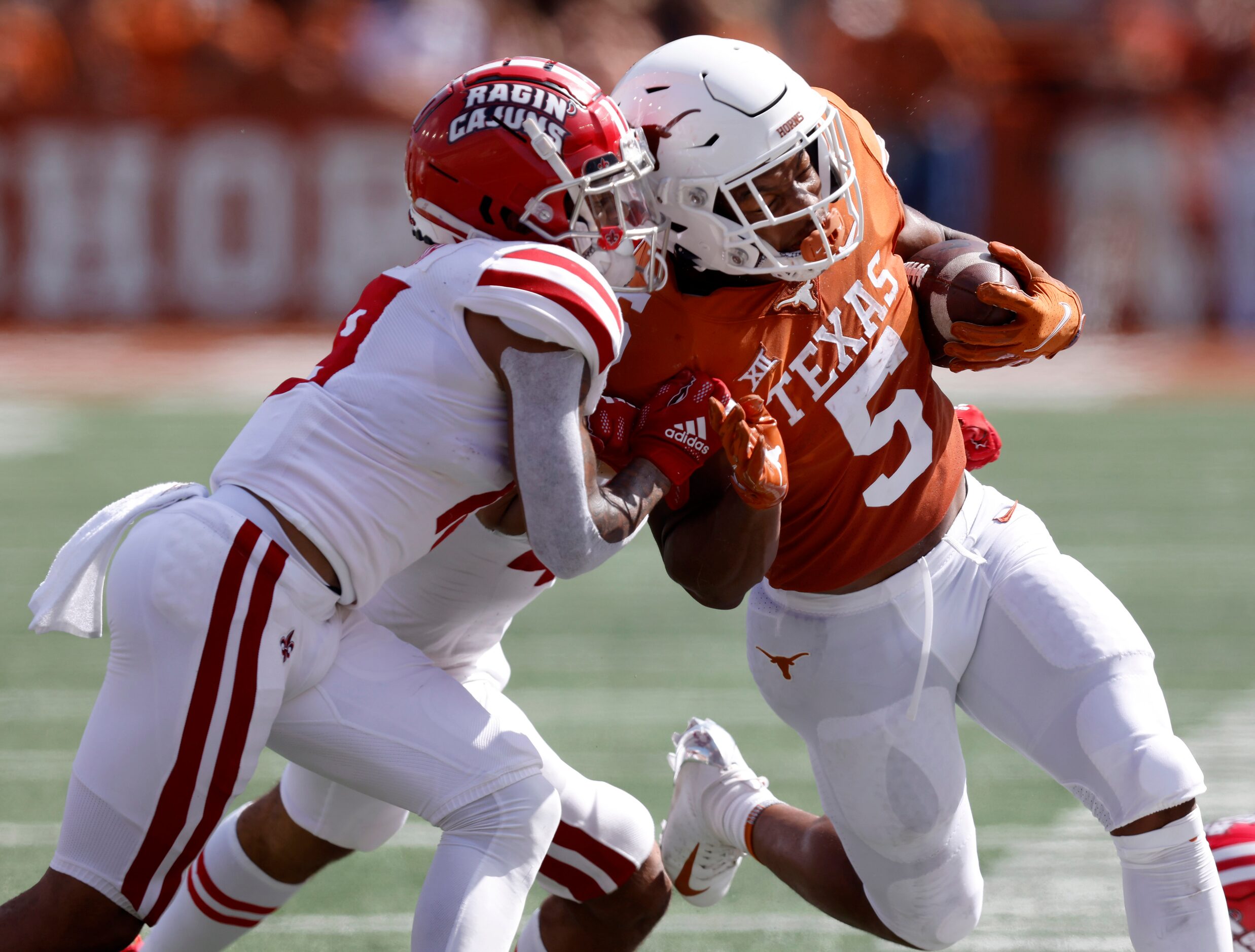 Texas Longhorns running back Bijan Robinson (5) is pushed out of bounds by...