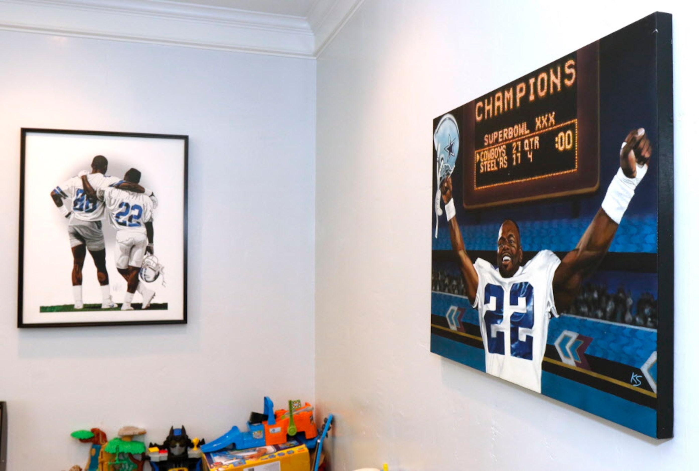 Portraits of former Dallas Cowboys running back Emmitt Smith are displayed in the game room...