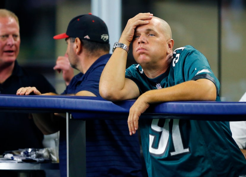 A Philadelphia Eagles fan reacts as his team lets the Dallas Cowboys back into the game in...