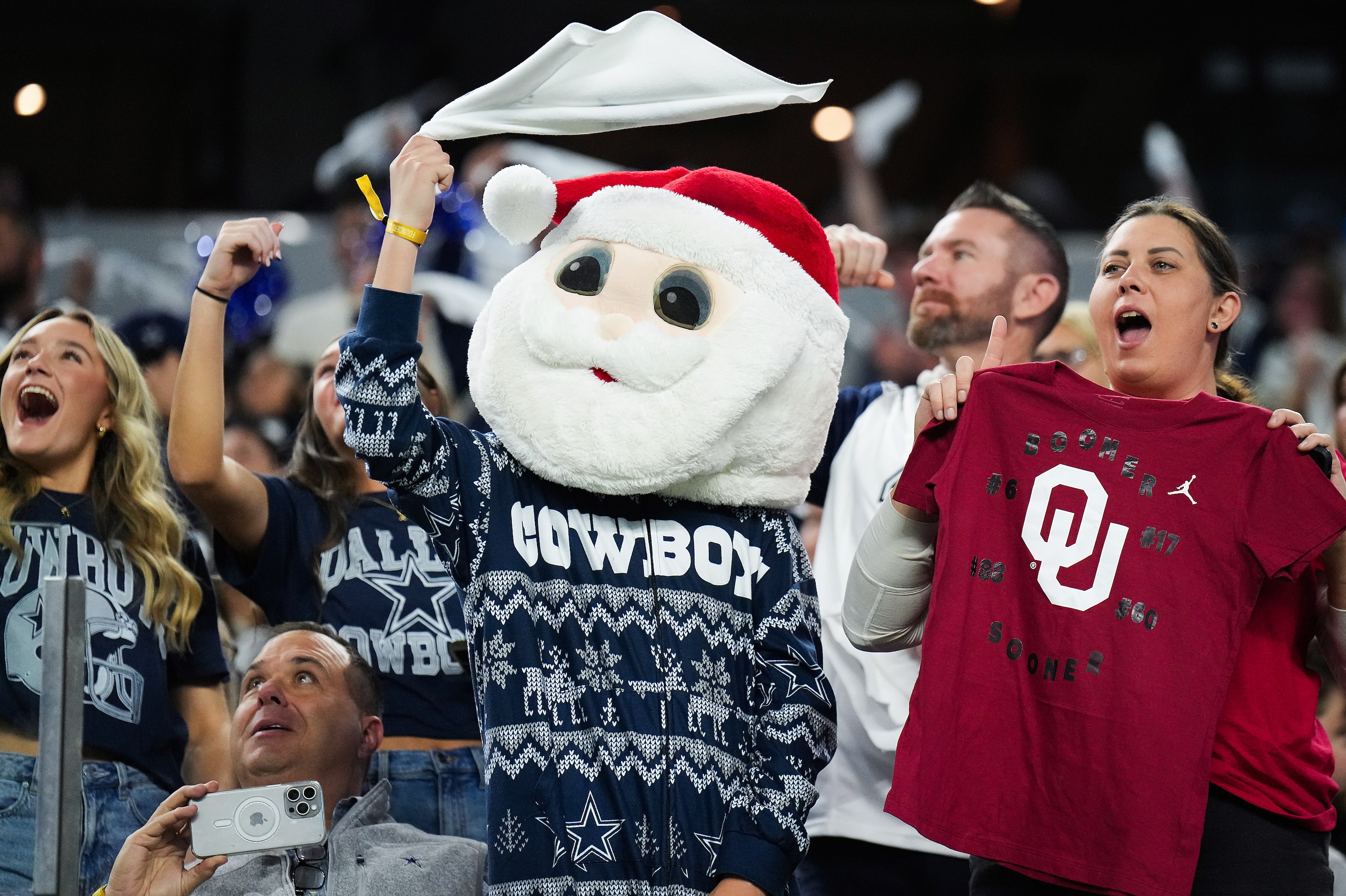 Fans cheer the opening kickoff of the first half of an NFL football game between the Dallas...