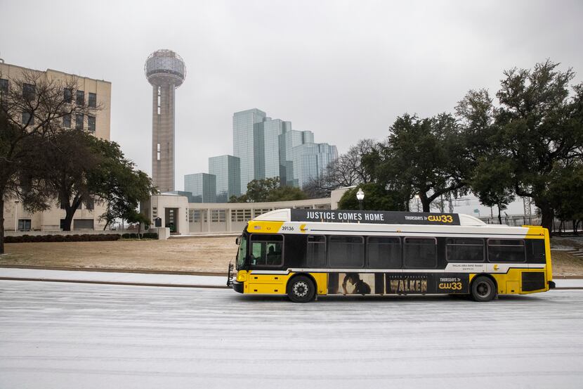 A DART bus drives along a layer of sleet on Sunday, Feb. 14, 2021, in Dallas.