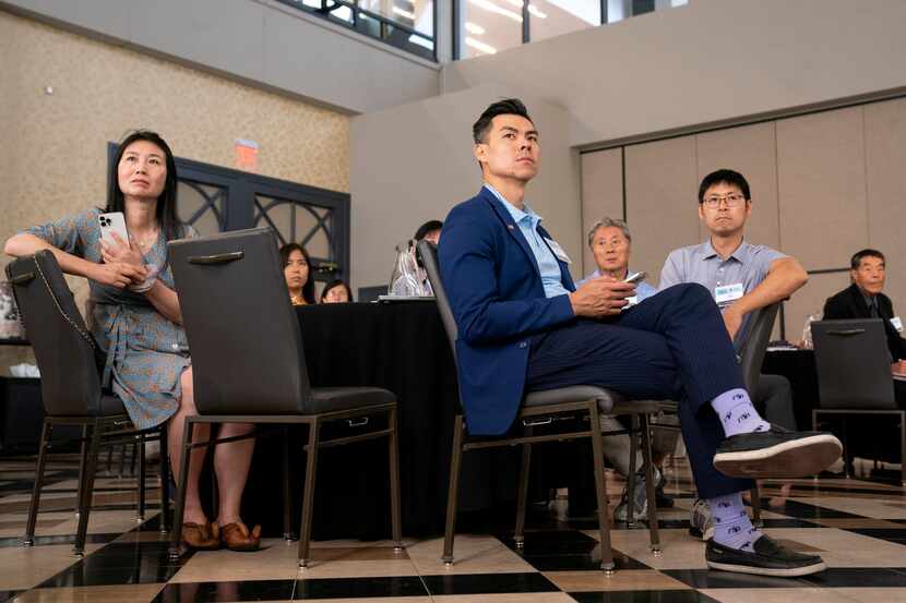 Calvin Wong, center, and Sheky Chen, left, listen during a forum on hate crimes against AAPI...
