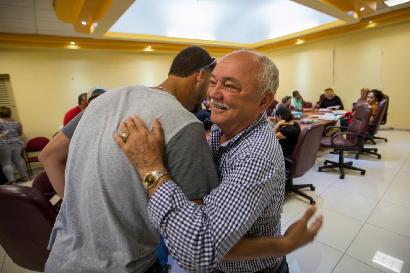 Texas Rangers pitcher Alex Claudio hugs his hometown mayor, Alfredo Alejandro Carrion, as he...