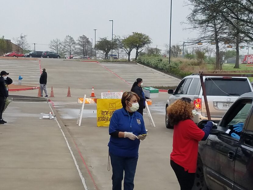 Teachers at Legacy Preparatory Charter Academy in Mesquite distribute equipment to allow...