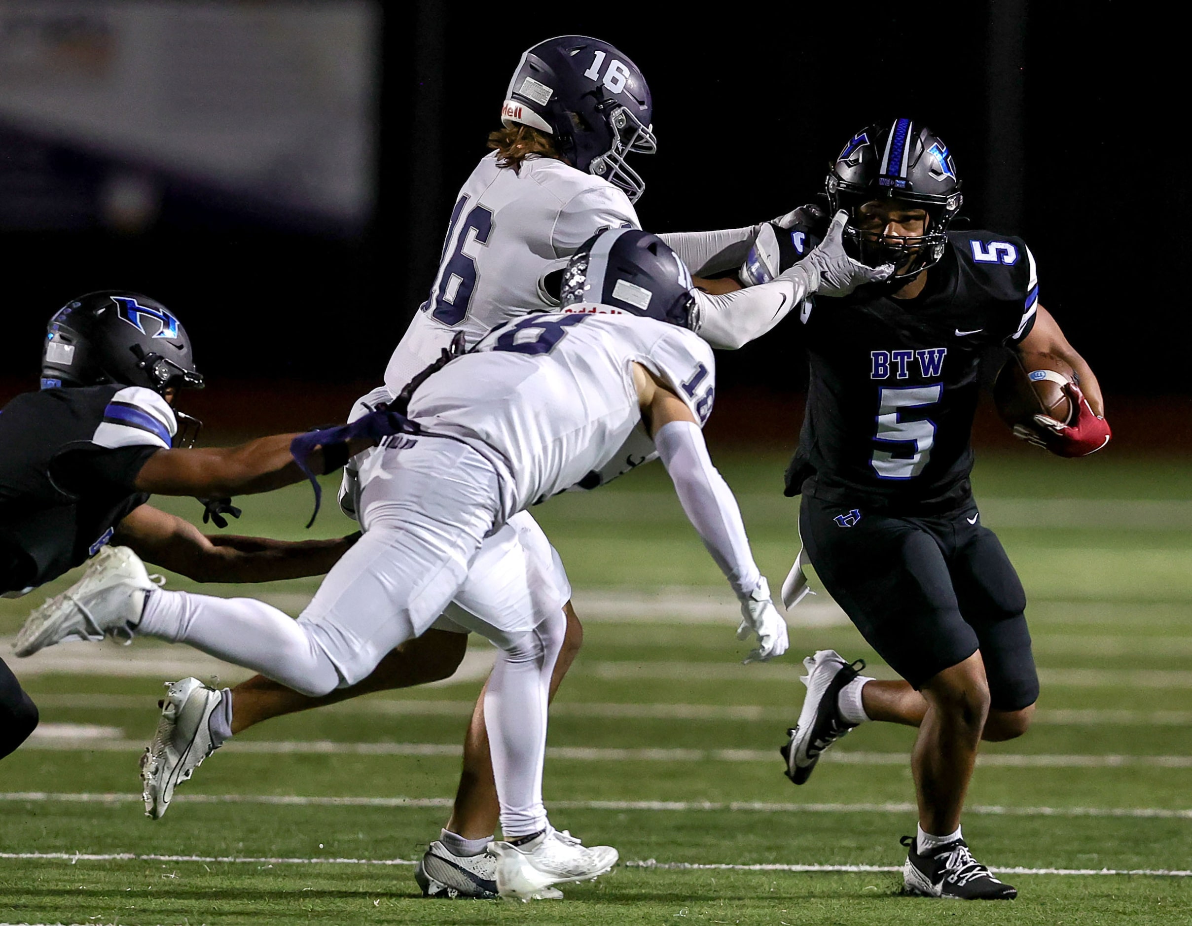 Hebron running back Ayson McCray Jones (5) gets his facemask pulled by Flower Mound safety...