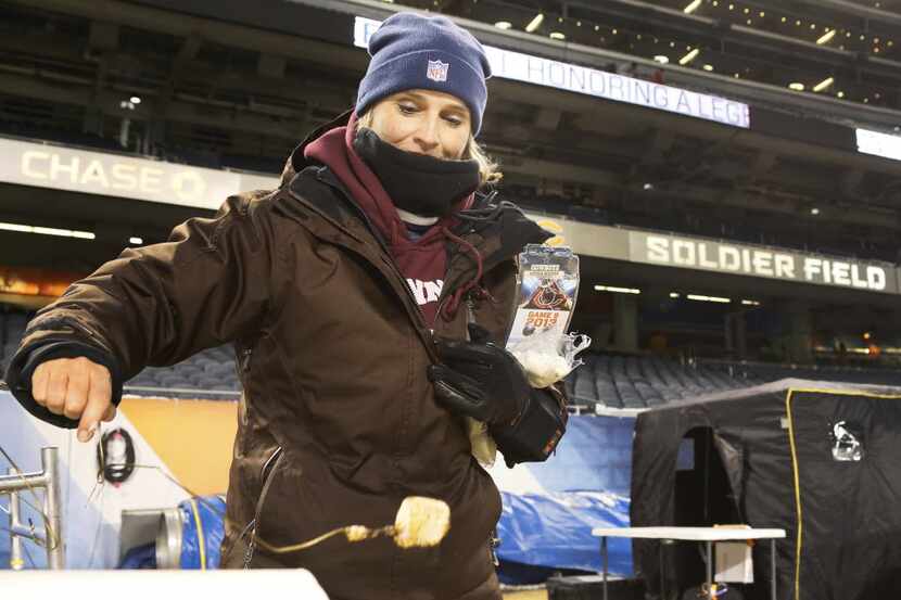 Dallas Cowboys radio sideline reporter Kristi Scales roasts a marshmallow on the on-field...