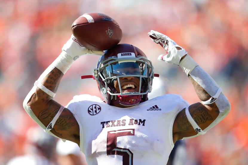 Texas A&M running back Trayveon Williams (5) reacts after scoring a touchdown against Auburn...