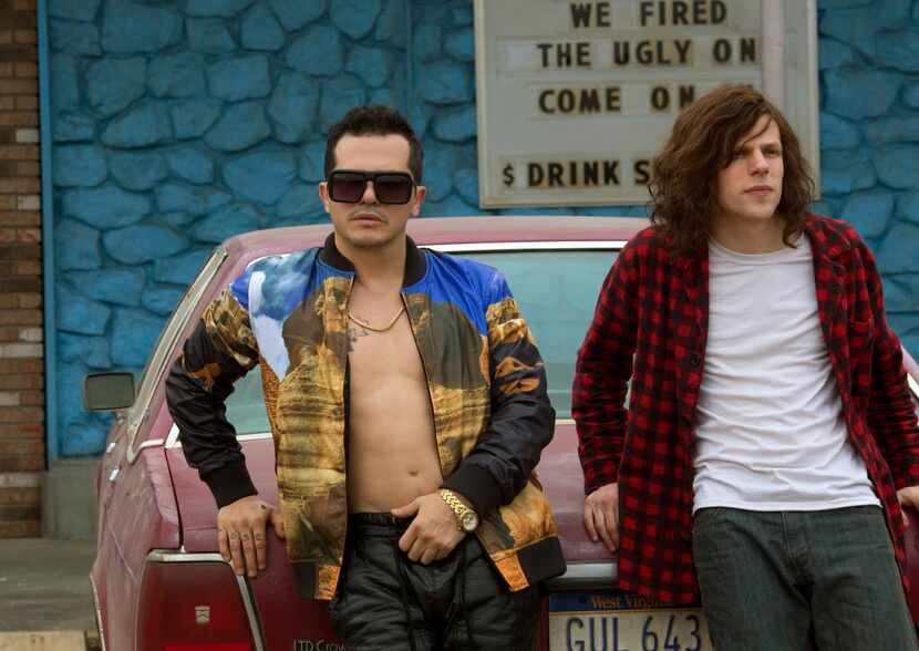 In this image released by Lionsgate, John Leguizamo, left, and Jesse Eisenberg appear in a...