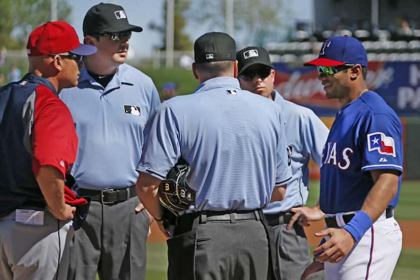 Seattle Seahawks quarterback Russell Wilson talks with the umpires as he takes the Rangers'...
