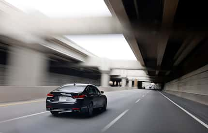 Cars drive along the LBJ TEXpress Lanes below I-635 in Dallas, February 8, 2024.