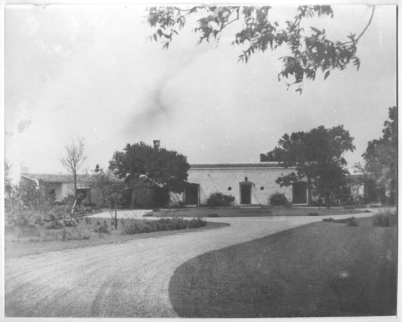 This image, dated 1940, shows the driveway and gardens leading to the DeGolyer Estate near...