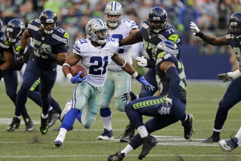 Dallas Cowboys running back Ezekiel Elliott (21) rushes against the Seattle Seahawks in the...