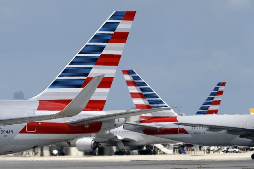In this May 27, 2015, photo, American Airlines aircraft taxi at Miami International Airport...