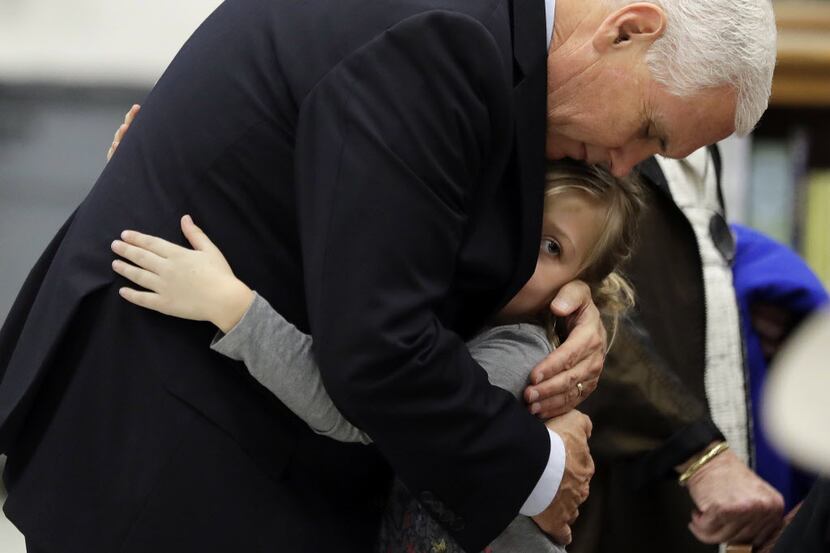 Vice President Mike Pence hugs Evelyn Hill at Florseville High School during a stop,...