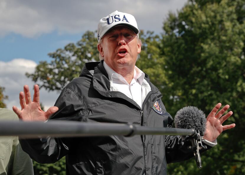 President Donald Trump answers a question from the media as he arrives at the White House on...