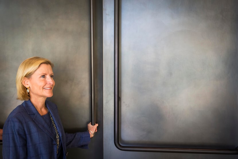 Nancy Perot opens the doors to a conference room during a tour of the family business' new...