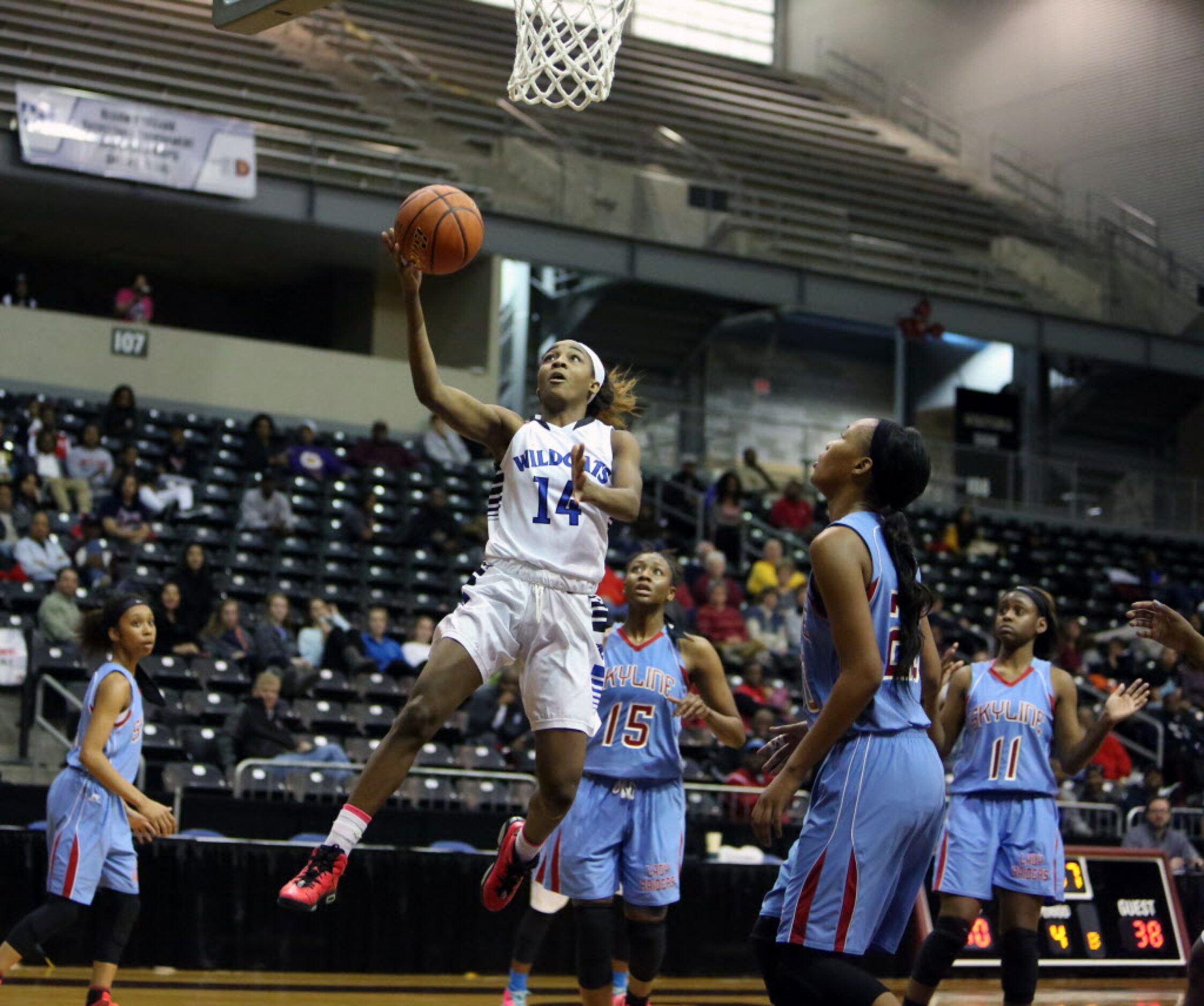 Dekaney guard Keishawna Scott drives to the hoop for an open layup during the 4th quarter of...