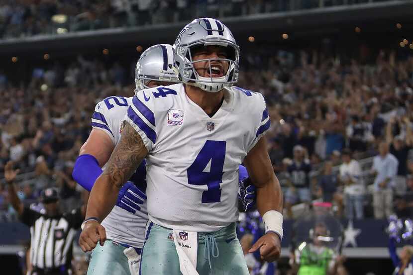 ARLINGTON, TX - OCTOBER 08:  Dak Prescott #4 celebrates his touchdown run with Jason Witten...