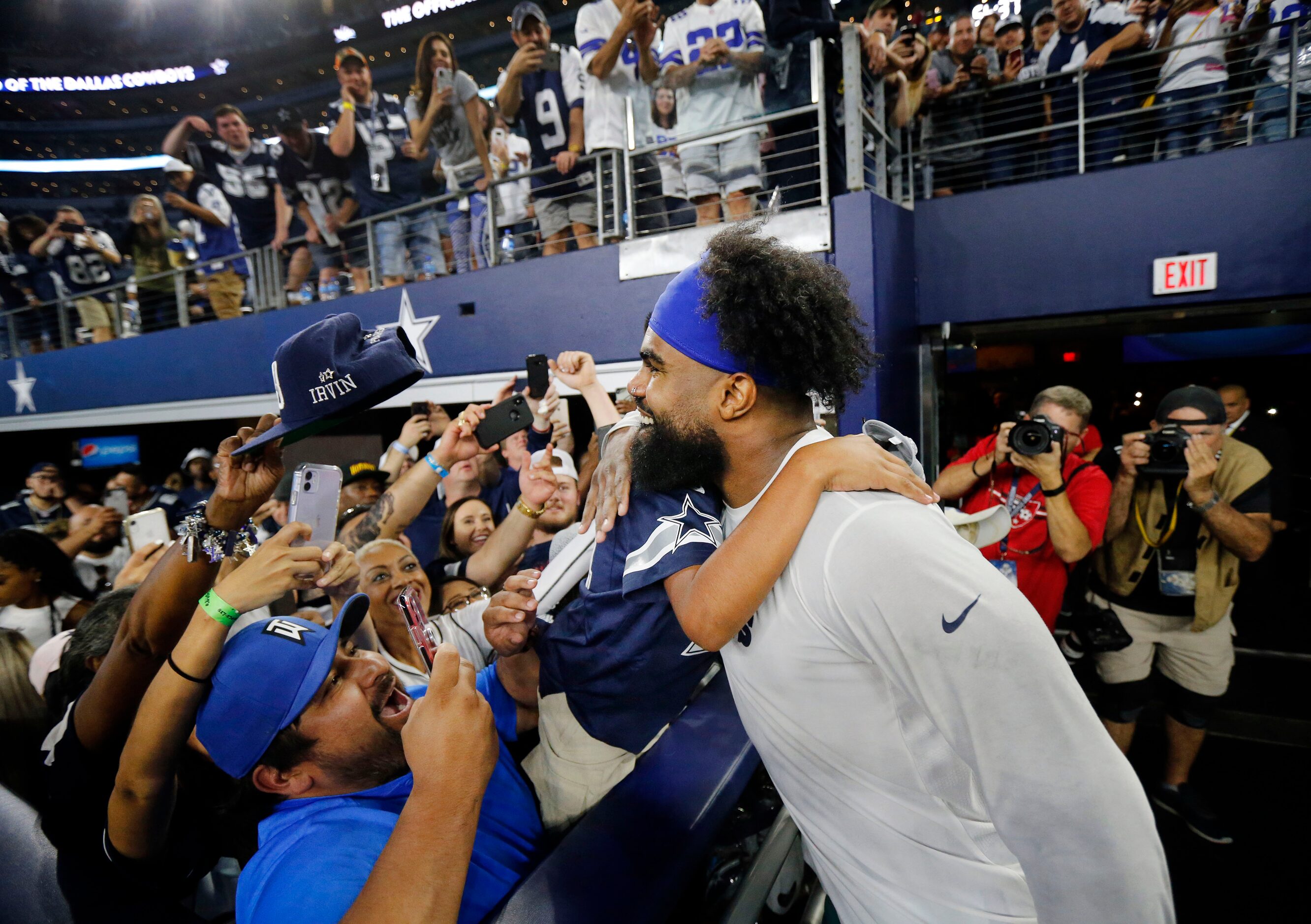 A young fan receives a hug and an autograph from Dallas Cowboys running back Ezekiel Elliott...