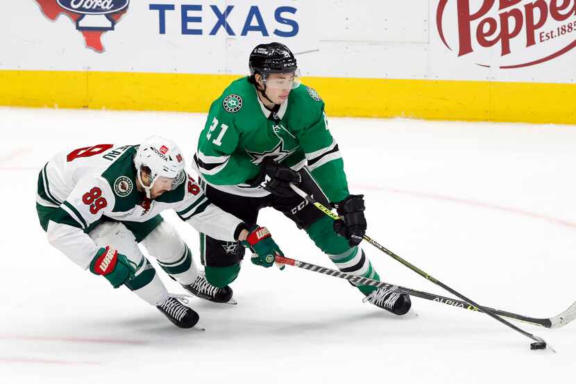 Dallas Stars left wing Jason Robertson (21) and Minnesota Wild center Frederick Gaudreau...