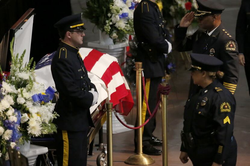 Dallas Police Chief David Brown, top right, salutes  fallen Officer Patrick Zamarripa during...