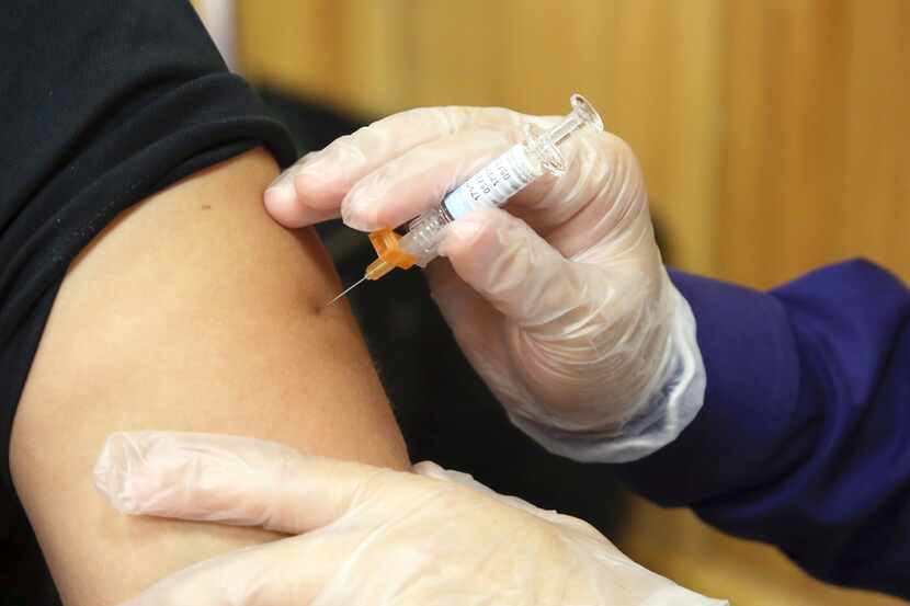 In this Friday, Sept. 22, 2017 file photo, a flu vaccine injection is administered at the...