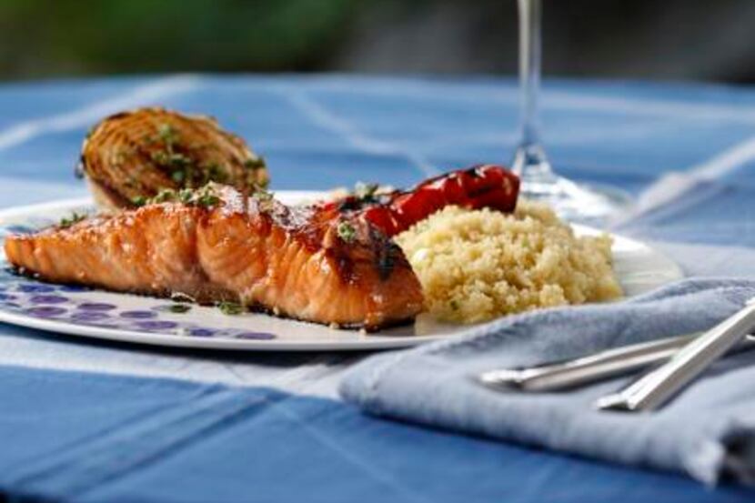 
Grilled Salmon with Sweet Onions and Red Bell Peppers is served with Quick Couscous Pilaf. 

