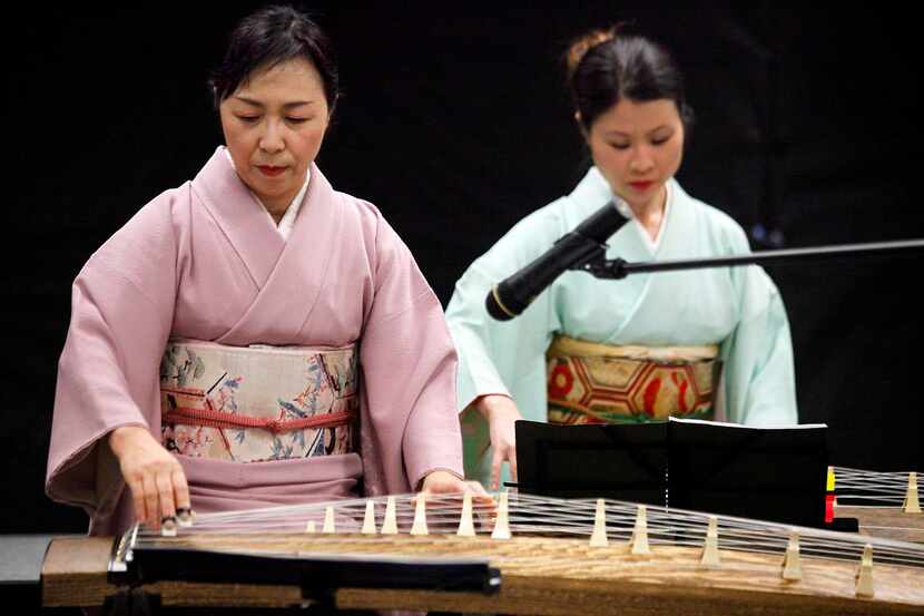 
Fukimo Coburn (left) of Fort. Worth, and Mayumi Nolan of Lewisville, play the koto as the...
