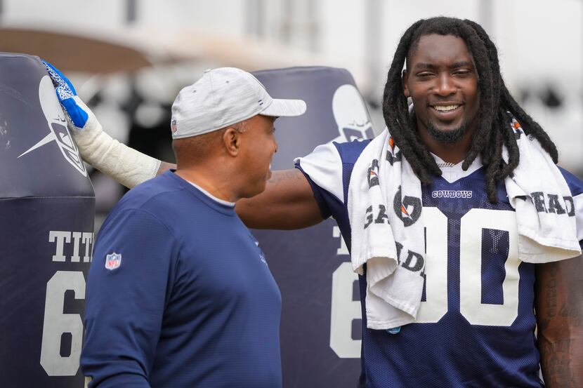 Dallas Cowboys defensive end DeMarcus Lawrence (90) laughs with sr. defensive assistant...