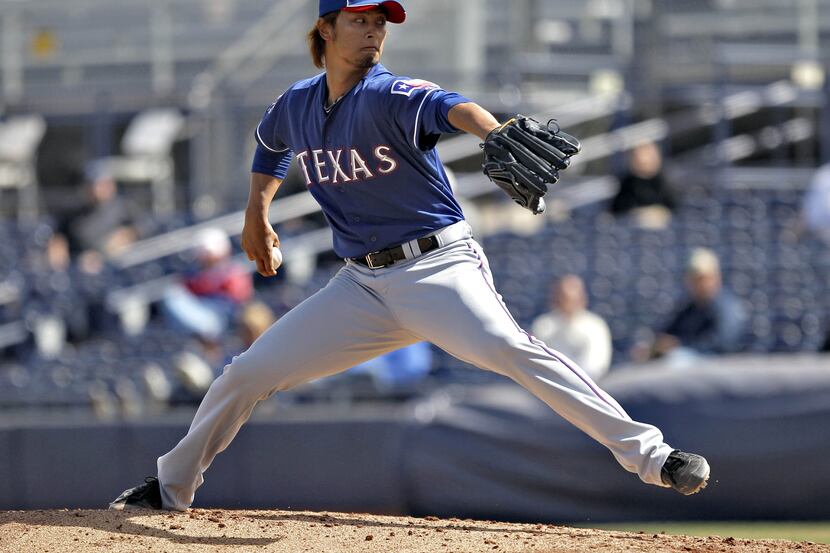 Texas Rangers pitcher Yu Darvish throws in a spring training baseball game against the San...