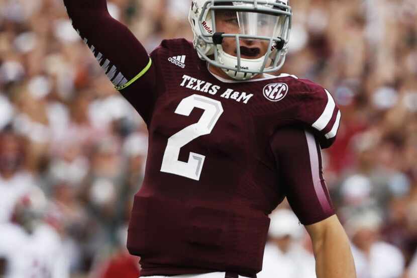 Johnny Manziel #2 of the Texas A&M Aggies celebrates after throwing a first quarter...