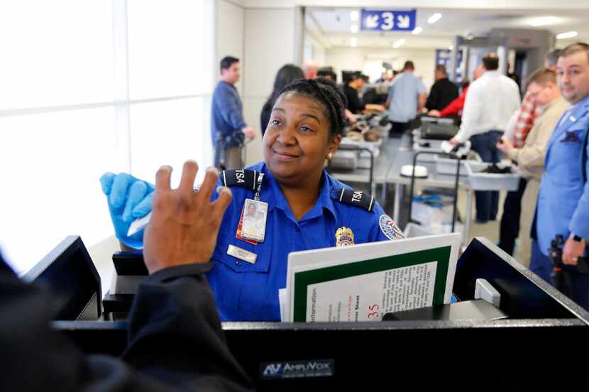 TSA agent Michelle Bender checked a person's license at the security checkpoint in Terminal...