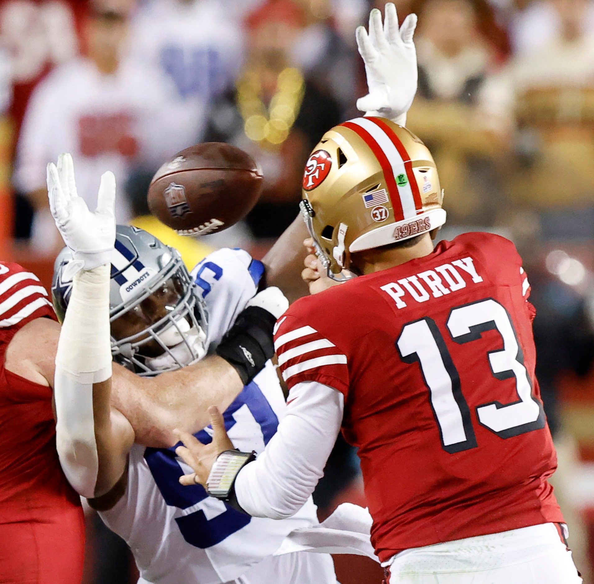 San Francisco 49ers quarterback Brock Purdy (13) looses control of a pass as Dallas Cowboys...