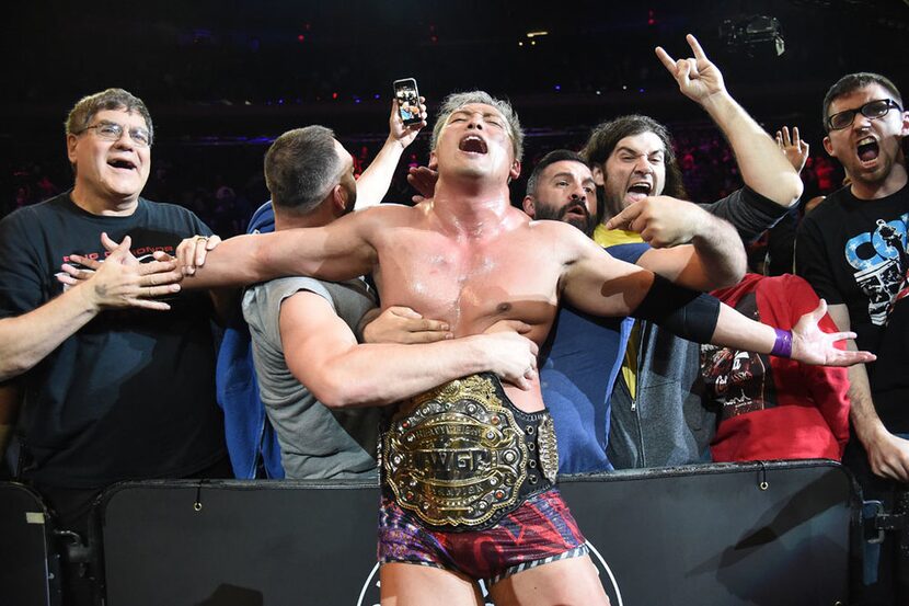 Kazuchika Okada celebrates with fans after winning the IWGP Heavyweight Championship at...