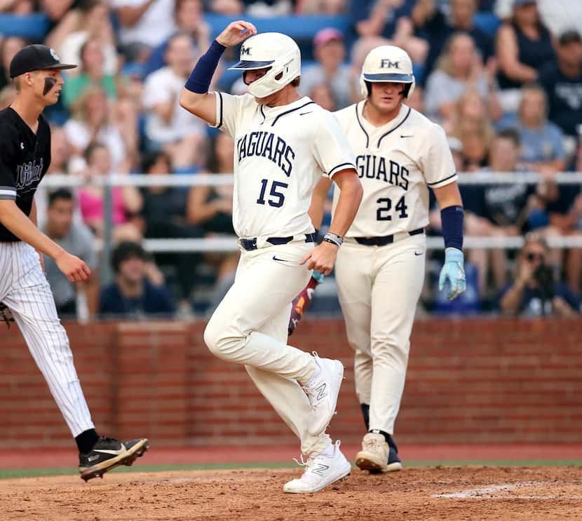 Flower Mound third baseman Josh Glaser (15) comes across home plate for a run against Denton...