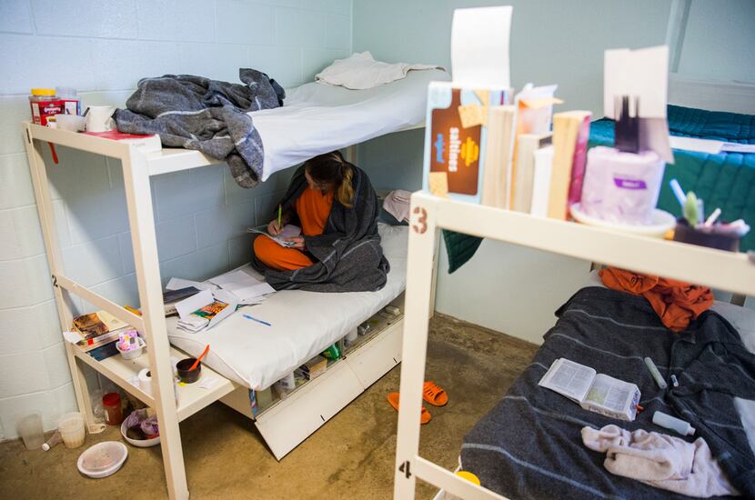 Inmate Beth Wesner, 25, (lower left) sketches on her bunk on Oct. 25 at Burnet County Jail...